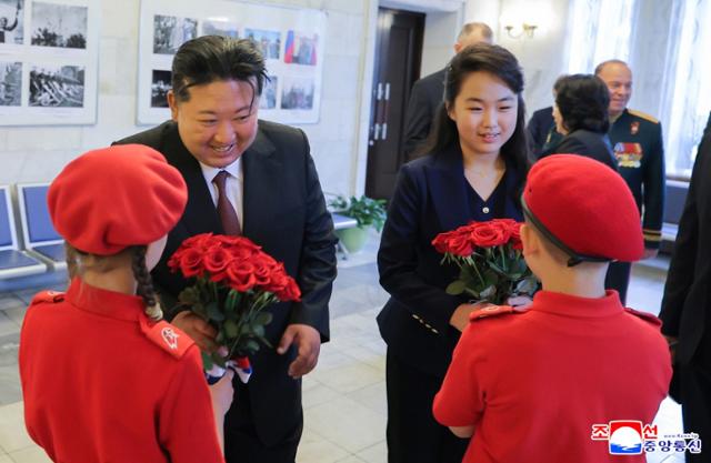 Kim Ju-ae, right, daughter of North Korean leader Kim Jong-un, arrives alongside her father for a visit to the Russian Embassy in Pyongyang in May 2025. Korean Central News Agency